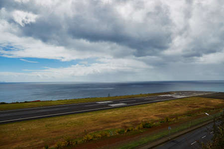 View of Madeira airport Cristiano Ronaldo runway near the ocean with dramatic skyの写真素材