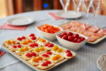 Different finger food snacks with cheese and vegetables ready to eat on party or home dinnerの写真素材