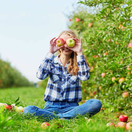 Woman holding crate with ripe red apples on farm. Autumn, harvest and gardening conceptの写真素材