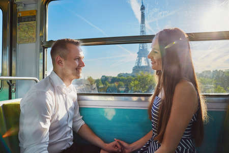 Couple traveling in subway train with view to the Eiffel tower in Paris, Franceの写真素材