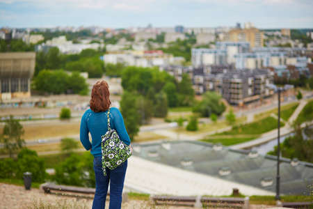 Girl looking at beautiful panorama of Vilnius Old Town from Gediminas hill, Lithuaniaの写真素材
