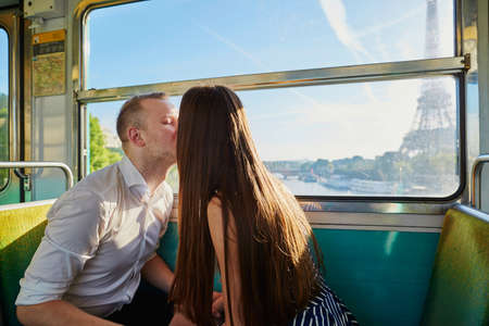 Couple traveling in subway train with view to the Eiffel tower in Paris, Franceの写真素材