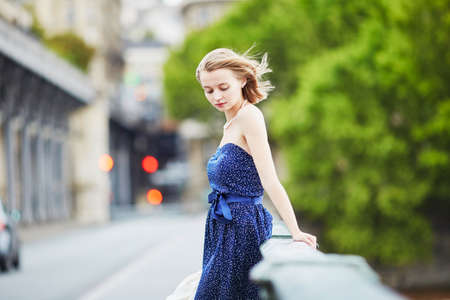 Beautiful young elegant French woman in Paris outdoorsの写真素材