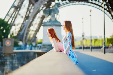 Two friends near the Eiffel tower in Paris, France; enjoying the view