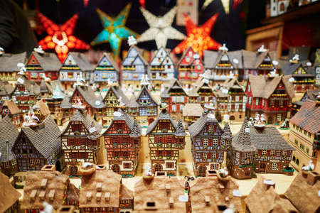 Variety of ceramic houses and star garlands at traditional Christmas market in Strasbourg, Alsace, Franceの写真素材