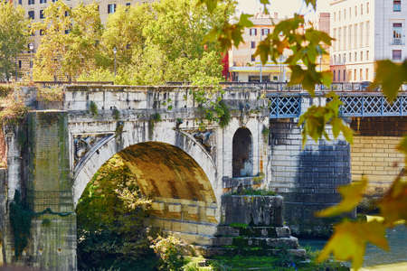 Old historical bridge over the Tiber in Rome, Italyの写真素材