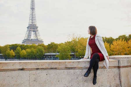 Beautiful young woman walking in Paris on a bright fall dayの写真素材