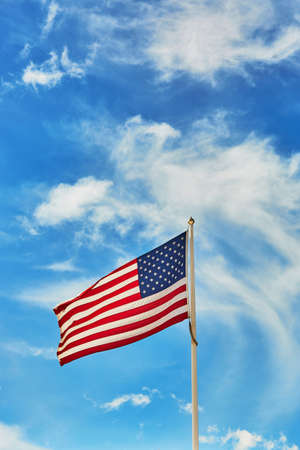 National flag of the United States of America over the blue skyの写真素材