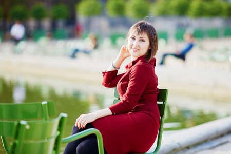 Young woman spending her weekend in Tuileries garden of Paris, Franceの写真素材