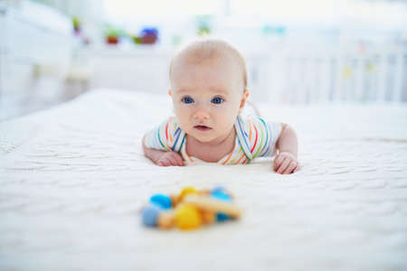 Blue eyed baby girl doing tummy timeの写真素材