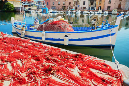 Boat and red fishing net in Bosa, Sardinia, Italyの写真素材