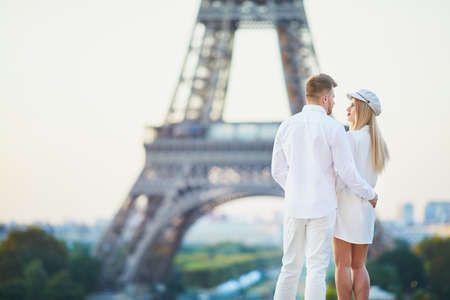 Romantic couple having a date near the Eiffel tower. Tourists in Paris enjoying the cityの写真素材