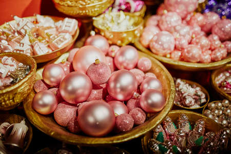 Many glass baubles for Christmas tree. New year decoration on marketの写真素材