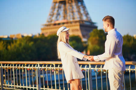 Romantic couple having a date near the Eiffel tower. Tourists in Paris enjoying the cityの写真素材