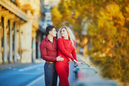 Romantic couple in love on Bir-Hakeim bridge on a fall day in Paris, Franceの写真素材