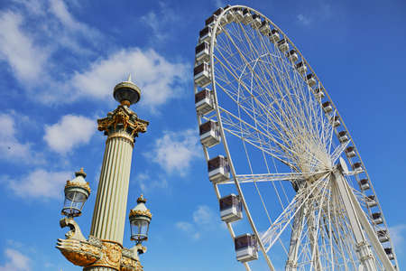Gondolas of Parisian Ferris Wheel over the blue skyの写真素材