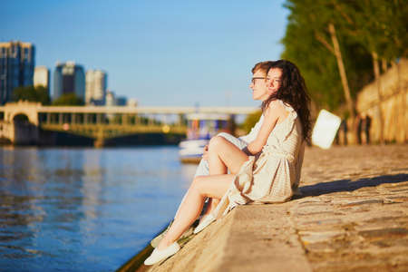 Happy romantic couple in Paris, near the river Seine. Tourists spending their vacation in Franceの写真素材
