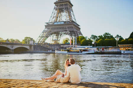 Happy romantic couple in Paris, near the Eiffel tower. Tourists spending their vacation in Franceの写真素材