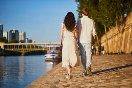 Happy romantic couple in Paris, near the river Seine. Tourists spending their vacation in Franceの写真素材