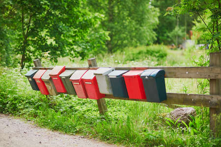 Row of colorful postboxes in the Finnish countrysideの写真素材