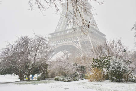 Scenic view to the Eiffel tower on a day with heavy snow. Unusual weather conditions in Paris