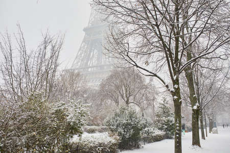 Scenic view to the Eiffel tower on a day with heavy snow. Unusual weather conditions in Paris