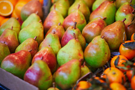 Large heap of fresh ripe organic pears on farmer market in Paris, France