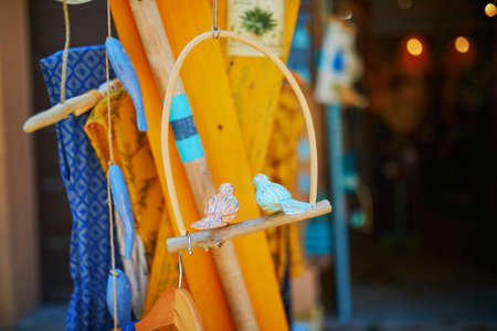 Beautiful wooden birds for sale on a street of Mediterranean town of Collioure, Southern France