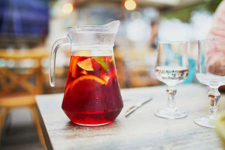 Big jar of delicious cold sangria, alcoholic beverage made from wine and fruits, originating from Spain and Portugalの写真素材