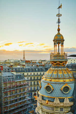 Beautiful Parisian skyline with roofs and dramatic colorful sunsetの写真素材