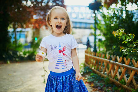 Happy cheerful toddler girl walking in park in Paris, Franceの写真素材