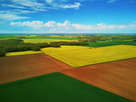 Scenic aerial drone view of yellow rapeseed fields in Ile-de-France, Franceの写真素材