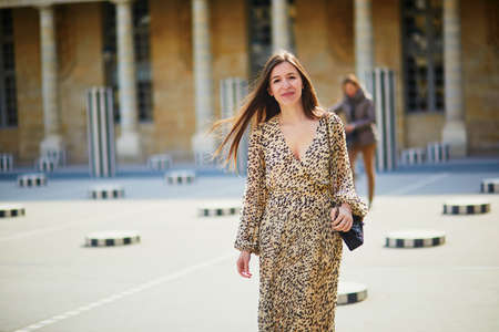 Young woman with long hair in Paris, France. Beautiful tourist in Palais Royal gardenの写真素材