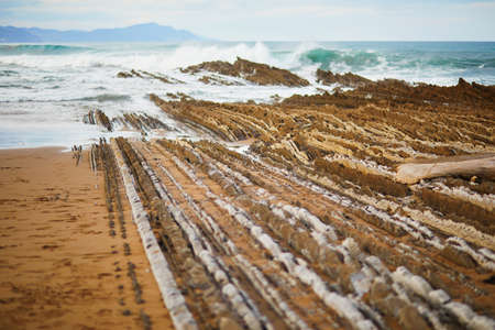 Famous flysch of Zumaia, Basque Country, Spain. Flysch is a sequence of sedimentary rock layers that progress from deep-waterの写真素材