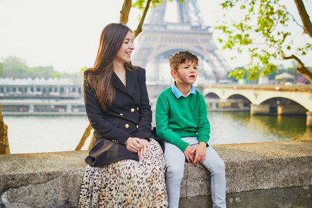 Happy family of two enjoying their trip to Paris, France. Mother and son near the Eiffel tower in Parisの写真素材