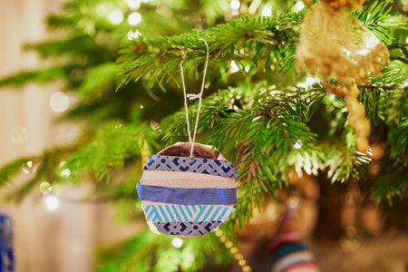 Christmas tree decorated with different colorful toys at home