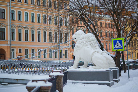 Lyons on Bridge of Four Lyons on Griboedov canal embankment on a cold snowy winter day in Saint Petersburg, Russiaの写真素材