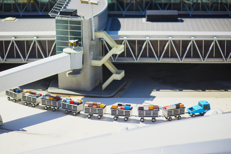 THE HAGUE, THE NETHERLANDS - APRIL 26, 2022: Models of luggage carts in Schiphol International airport at Madurodam miniature park, The Hague, the Netherlands, Hollandのeditorial素材