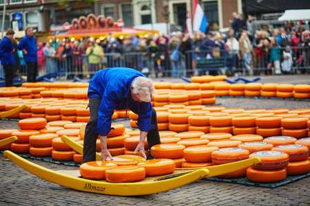 ALKMAAR, THE NETHERLANDS - APRIL 29, 2022: Cheese carriers walking with cheeses at famous Dutch cheese market in Alkmaar, the Netherlandsのeditorial素材
