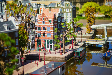 THE HAGUE, THE NETHERLANDS - APRIL 26, 2022: Models of Dutch boats and canals at Madurodam miniature park, The Hague, the Netherlands, Hollandのeditorial素材