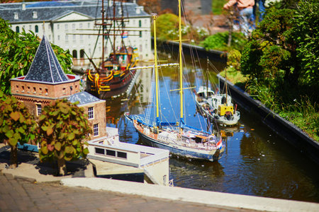 THE HAGUE, THE NETHERLANDS - APRIL 26, 2022: Models of Dutch boats and canals at Madurodam miniature...