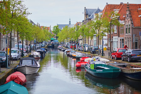 ALKMAAR, THE NETHERLANDS - APRIL 29, 2022: Scenic view of Alkmaar with its canals, bridges and boatsのeditorial素材