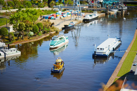 THE HAGUE, THE NETHERLANDS - APRIL 26, 2022: Models of Dutch boats and canals at Madurodam miniature park, The Hague, the Netherlands, Hollandのeditorial素材