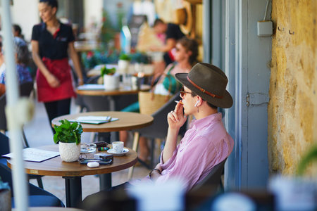 LOURMARIN, FRANCE - JULY 13, 2022: People enjoying drinks in cafe on a hot summer dayのeditorial素材