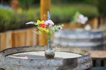Wooden table in form of barrel decorated with flowers in outdoor cafe in Amsterdam, the Netherlandsの写真素材