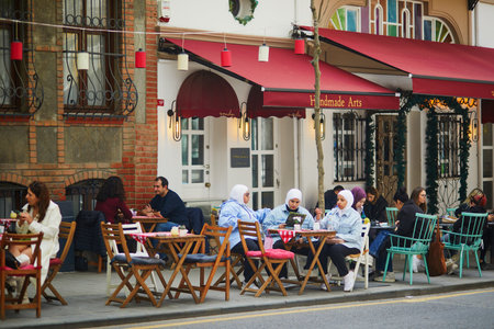 ISTANBUL, TURKEY - APRIL 23, 2023: People in outdoor cafes in Kuzguncuk, a neighborhood in Uskudar district on the Asian side of the Bosphorus in Istanbul, Turkey, known for its Ottoman wooden housesのeditorial素材