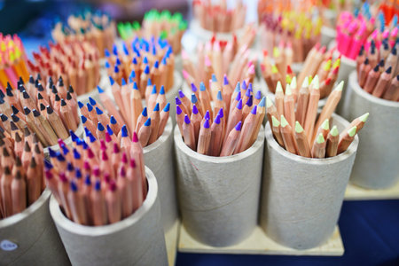 Many wooden colorful pencils in ceramic mugsの写真素材