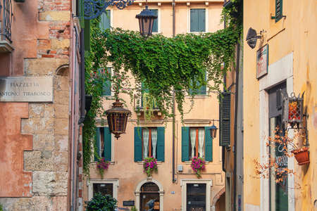 VERONA, ITALY - July 19th, 2019: Small square in historic center of the city, typical architecture and atmosphereのeditorial素材