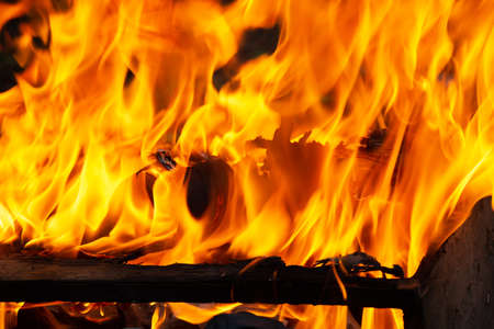 Old wooden piece of furniture on fire, burning old things