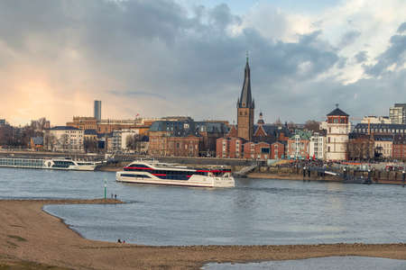 Duesseldorf embankment on warm spring evening on week-end, many people walkingのeditorial素材